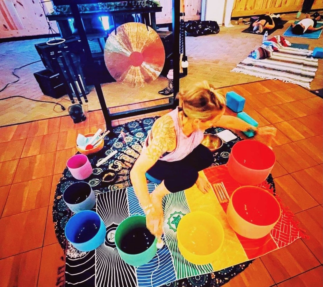 woman performing with singing bowls